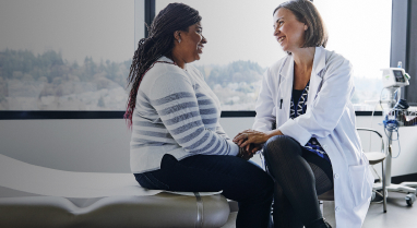 Doctor talking to adult patient