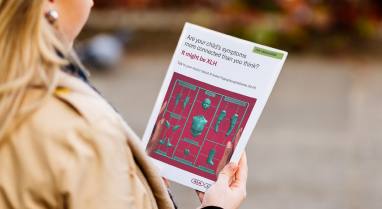 Woman holding brochure with campaign on the cover