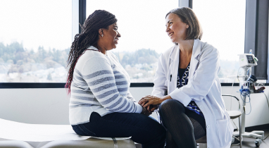 Doctor talking to adult patient